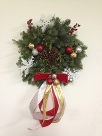 Handmade Noble fir wreath decorated with holly and seasonal accents